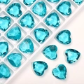 Macro shot of 12mm blue heart-shaped crystal glass rhinestones with faceted finish - Lake Blue