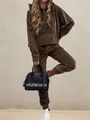 Detail of premium brown velvet tracksuit with hoodie and matching joggers for a luxury look - Dark Brown
