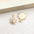 Golden sun-shaped metal charms with a smiling face and 'made with a smile' engraving - 1pc Sun Charm