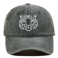 Close-up of intricate white tiger head embroidery on a vintage washed cotton baseball cap - Green
