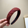 Close-up of red tweed woven headband with high-top sponge design and premium texture - Wine Red + Black Thread