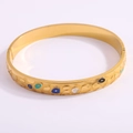Golden titanium steel bangle featuring colorful evil eye enamel patterns on white background - Gold Textured Horseshoe Bangle
