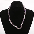 Close-up of handmade natural purple crystal chips necklace on a black mannequin - Amethyst