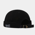 Detail of black corduroy docker hat featuring brand side label and adjustable metal buckle - Adjustable / Black