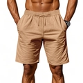 Detail of khaki linen shorts featuring elastic drawstring waistband and side pockets - Dark Camel