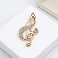 Elegant gold musical treble clef brooch with white rhinestones on display - Gold Musical Note (256)