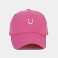 Detail of pink cotton baseball cap featuring white embroidered smiley face and vent holes - Adjustable / Rose Red