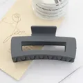 Close-up of matte dark gray rectangular hair claw clip on aesthetic floral card - Dark Grey