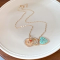 Detail of gold necklace with mint green enamel heart and crystal sunburst charms - Necklace #31 - Gold - Green