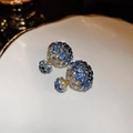Macro shot of silver needle earrings featuring blue and clear rhinestones on ceramic - Classic Blue White Double Ball Rhinestone Studs (10#)
