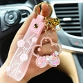 Pink quicksand cherry blossom acrylic keychain with a soft lucky wrist strap and gold bell - Pink
