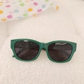 Stylish dark green kids sunglasses with rivet details and UV protection on white faux fur - Green
