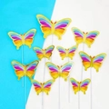 Set of 9 iridescent butterfly cake toppers with gold foil edges on blue background - Colorful Gold-Edged Butterfly Material Kit