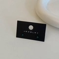 Close-up of deep green round bean stud earrings on a black jewelry display card - Dark Green Stud Earrings