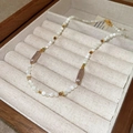 Handmade beaded necklace with pearls and green accents in a wooden jewelry box - Necklace - Gold White