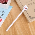 Cute white gel pen with a cartoon character charm on a cozy wooden desk setup - Red Nose Bear White