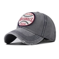 Detail view of washed grey baseball cap with embroidery patch and distressed brim wear - Gray