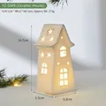 White ceramic house ornament with star cutouts and warm glowing light for Christmas - Ceramic House