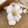 Elegant white tulip hair clip with yellow pistil on rustic wooden background - Blue White Gradient