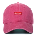Close-up of the Blessed embroidery patch on a vintage washed pink baseball cap - Rose Red