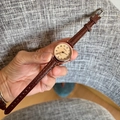 Close-up of small numeral watch with beige textured dial and brown leather strap - Coffee With Coffee Dial