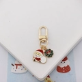 Detailed view of Christmas keychain with Santa and wreath charms in gold finish - Santa Claus and Wreath