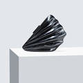 Detailed close-up of a shell-shaped black acrylic clutch with elegant marble texture - Black
