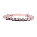 Macro shot of translucent pink and purple natural stone beads with gold accents on the bracelet - Rose Quartz + Amethyst