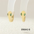 Macro shot of gold snake hoop earrings featuring green gemstone eyes and detailed scales - ER0842-B/Gold/Green Eyes