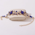 Elegant gold-tone bridal bracelet with navy blue teardrop crystals and sparkling rhinestones - Bracelet / Gold/Blue