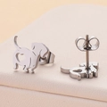 Macro shot of silver stainless steel dachshund stud earrings with cutout heart detail - Silver