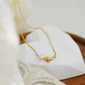 Elegant gold titanium dolphin necklace featuring a single white pearl on a fine chain - H1175 Dolphin Pearl Pendant Necklace Gold