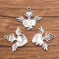 Silver winged heart charms with crown detail for DIY jewelry making on wooden background - 27B2-10 Crown Wing Heart
