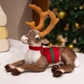 Brown plush reindeer toy in sitting pose with red vest and antlers for Christmas decor - Christmas Prone Small / 35 cm