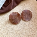 Close-up of geometric resin earrings with brown marble texture and golden glitter accents - Brown