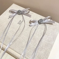 Detail of grey ribbon bow hair clips with rose center on a minimalist book background - Silver Ribbon Bow (Single)