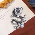 Silver dragon brooch with grey rhinestones and a pearl on a vintage paper background - Silver with Grey Pearl