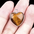 Handcrafted heart-shaped tiger eye stone pendant in a silver-tone bezel setting - Tiger Eye Silver Edging