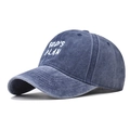 Close-up of white GOD'S PLAN embroidery on a washed navy blue distressed baseball cap - Navy Blue