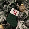 Green knit Christmas stocking featuring embroidered red letter Q with a festive santa hat - Green/Letter Q