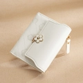 Short white quilted PU leather women's wallet featuring a stylish flower buckle closure - White