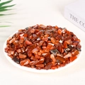 Natural red agate tumbled stone chips in a white dish for aromatherapy and decor - 100 Grams Of Red Agate (7-9mm)