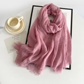 Pink cotton linen scarf with frayed edges and natural wrinkled texture on a white table - Pink
