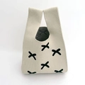 Detail of beige knitted tote bag with black cross pattern and textured fabric handles - Beige Butterfly