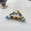 Detailed view of triangular tortoiseshell hair claw with marble texture and metal spring - 11.5cm (Large) / Translucent Blue Brown Marble