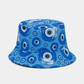 Close-up of the evil eye pattern and canvas texture on this blue reversible bucket hat - One Size / Blue