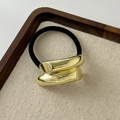 Irregular gold metal geometric hair tie with black elastic band on wood tray - Beveled Double-Row Gold