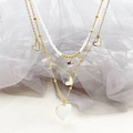 Detail of multi-layer stainless steel necklace with gold heart and star pendants - White Heart Star Necklace / White