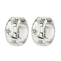 Close-up of silver huggie hoop earrings with star engravings and green zircon stones - Silver-Green Zirconia