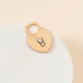 Macro shot of a matte gold heart lock pendant with two sparkling clear cubic zirconia stones - Heart Lock Pave Style (26#)